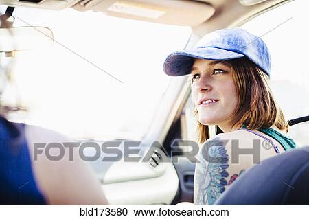 Caucasian couple driving in car on road trip View Large Photo Image Stock Image - Caucasian couple driving in car on road trip. Fotosearch