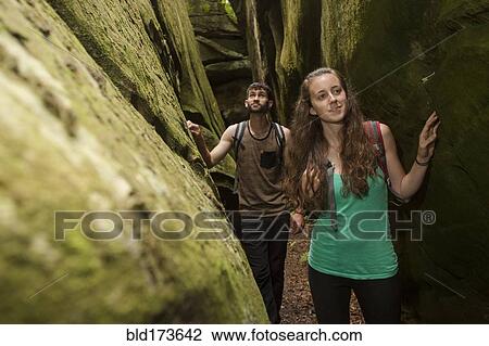Caucasian couple exploring cave View Large Photo Image Stock Image - Caucasian couple exploring cave. Fotosearch