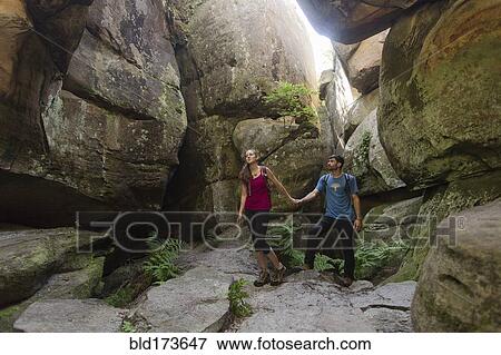 Caucasian couple exploring cave View Large Photo Image Stock Photo - Caucasian couple exploring cave. Fotosearch