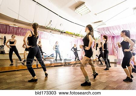 Stock Image - Caucasian dancers practicing in studio. Fotosearch