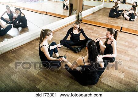 Caucasian dancers stretching in studio View Large Photo Image Stock Image - Caucasian dancers stretching in studio. Fotosearch