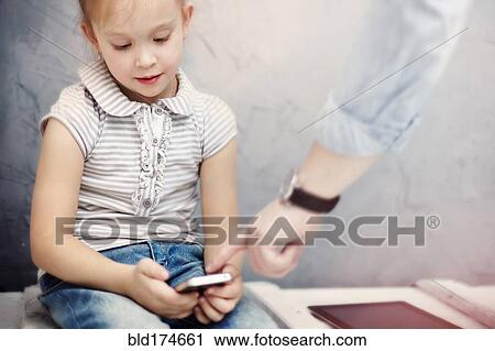 Stock Image - Caucasian father and daughter using digital tablet. Fotosearch