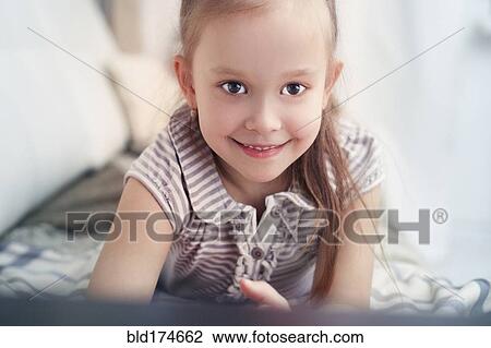 Caucasian girl laying on bed View Large Photo Image Stock Image - Caucasian girl laying on bed. Fotosearch