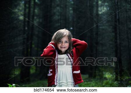 Picture - Caucasian girl smiling in forest. Fotosearch