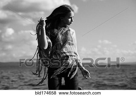 Stock Photo - Caucasian girl standing over lake. Fotosearch