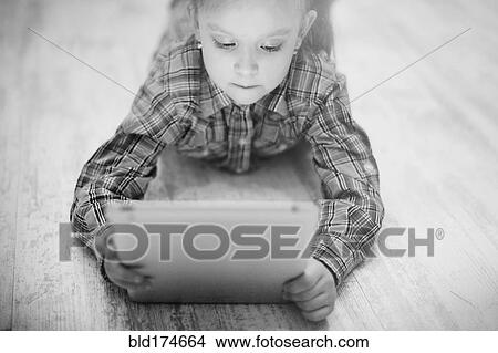 Caucasian girl using digital tablet View Large Photo Image Picture - Caucasian girl using digital tablet. Fotosearch