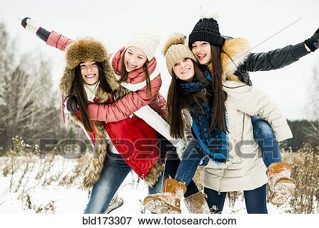 Stock Photo - Caucasian girls playing in snow. Fotosearch