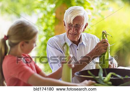 Caucasian grandfather and granddaughter shucking corn View Large Photo Image Stock Image - Caucasian grandfather and granddaughter shucking corn. Fotosearch