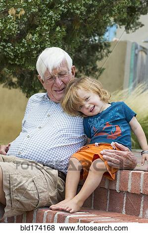 Caucasian grandfather and grandson hugging outdoors View Large Photo Image Stock Photo - Caucasian grandfather and grandson hugging outdoors. Fotosearch