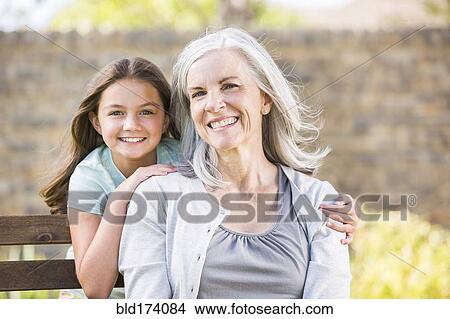 Caucasian grandmother and granddaughter smiling outdoors View Large Photo Image Picture - Caucasian grandmother and granddaughter smiling outdoors. Fotosearch