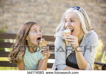Caucasian grandmother and granddaughter eating ice cream View Large Photo Image Stock Image - Caucasian grandmother and granddaughter eating ice cream. Fotosearch