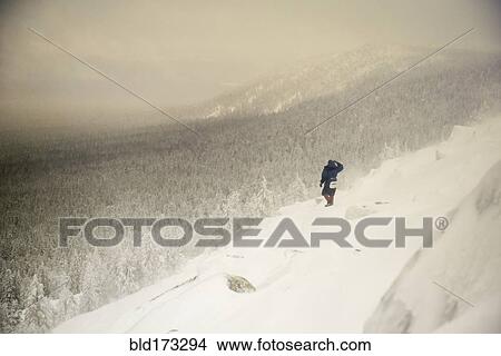 Caucasian hiker waking on snowy hillside View Large Photo Image Picture - Caucasian hiker waking on snowy hillside. Fotosearch