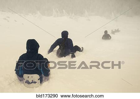 Caucasian hikers sledding on snowy hill View Large Photo Image Stock Image - Caucasian hikers sledding on snowy hill. Fotosearch