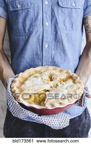 Caucasian man holding peach pie View Large Photo Image Stock Image - Caucasian man holding peach pie. Fotosearch