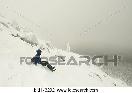 Caucasian man sledding on snowy mountain View Large Photo Image Stock Image - Caucasian man sledding on snowy mountain. Fotosearch