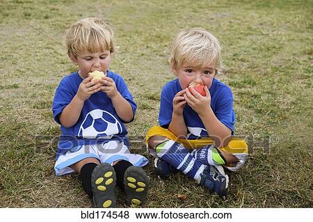 Caucasian soccer players eating apples View Large Photo Image Stock Photo - Caucasian soccer players eating apples. Fotosearch