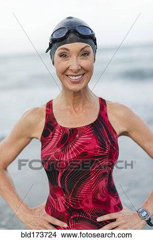 Caucasian swimmer smiling on beach View Large Photo Image Picture - Caucasian swimmer smiling on beach. Fotosearch