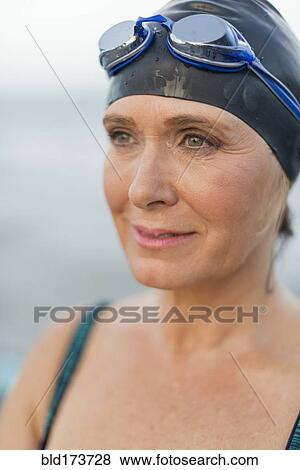 Stock Photo - Caucasian swimmer wearing goggles and swimming cap. Fotosearch