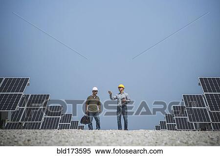 Caucasian technicians talking near solar panels View Large Photo Image Stock Photography - Caucasian technicians talking near solar panels. Fotosearch