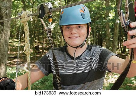 Stock Photo - Caucasian teenage boy on zip. Fotosearch