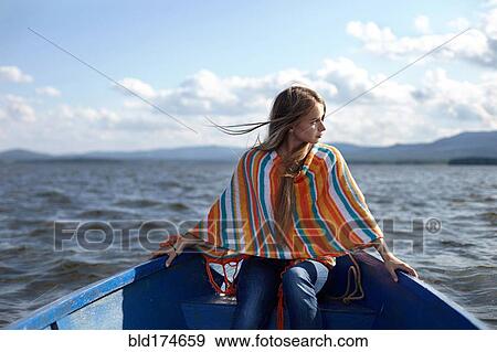 Stock Photo - Caucasian teenage girl in canoe on lake. Fotosearch