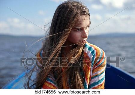 Stock Photograph - Caucasian teenage girl in canoe on lake. Fotosearch