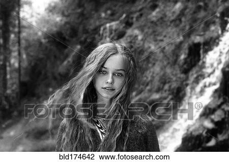 Stock Image - Caucasian teenage girl in forest. Fotosearch