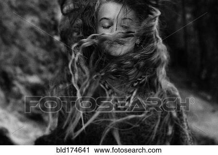 Stock Image - Caucasian teenage girl tossing her hair. Fotosearch