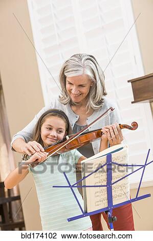 Caucasian woman giving student violin lessons View Large Photo Image Stock Image - Caucasian woman giving student violin lessons. Fotosearch