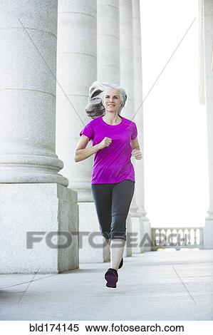 Caucasian woman jogging outside courthouse View Large Photo Image Stock Photography - Caucasian woman jogging outside courthouse. Fotosearch