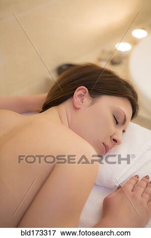 Caucasian woman laying on massage table View Large Photo Image Stock Photo - Caucasian woman laying on massage table. Fotosearch