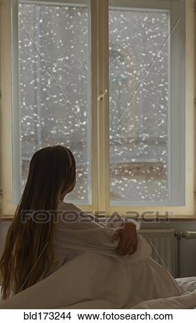 Caucasian woman looking out window View Large Photo Image Picture - Caucasian woman looking out window. Fotosearch