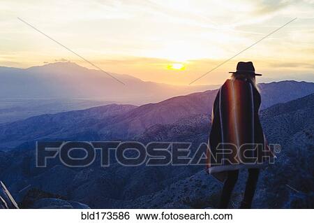 Stock Photograph - Caucasian woman overlooking remote desert landscape. Fotosearch