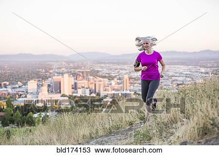 Caucasian woman running on hilltop over Salt Lake City, Utah, United States View Large Photo Image Stock Image - Caucasian woman running on hilltop over Salt Lake City, Utah, United States. Fotosearch