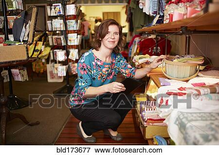 Stock Photo - Caucasian woman shopping in store. Fotosearch
