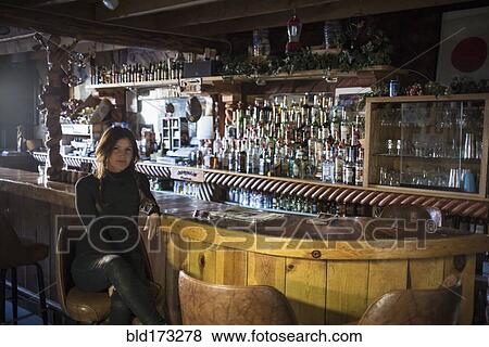 Caucasian woman sitting in empty bar View Large Photo Image Stock Photo - Caucasian woman sitting in empty bar. Fotosearch