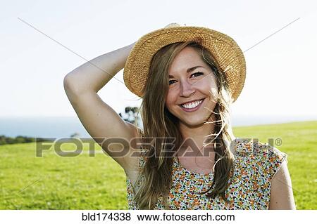 Caucasian woman sitting in field View Large Photo Image Stock Photo - Caucasian woman sitting in field. Fotosearch
