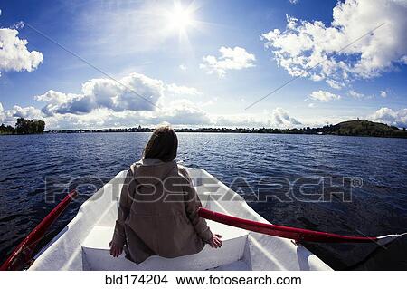 Caucasian woman sitting in rowboat View Large Photo Image Picture - Caucasian woman sitting in rowboat. Fotosearch