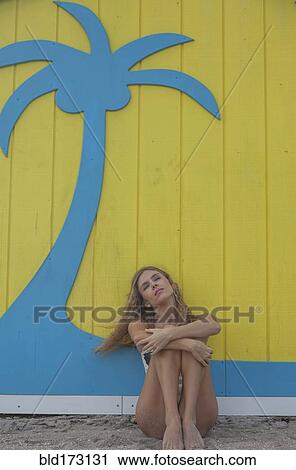 Caucasian woman sitting near wall View Large Photo Image Stock Image - Caucasian woman sitting near wall. Fotosearch