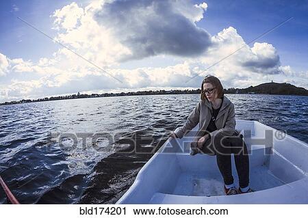 Caucasian woman sitting on rowboat View Large Photo Image Stock Image - Caucasian woman sitting on rowboat. Fotosearch