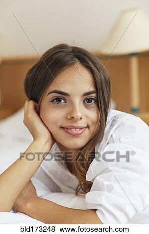 Caucasian woman smiling in bed View Large Photo Image Stock Photo - Caucasian woman smiling in bed. Fotosearch