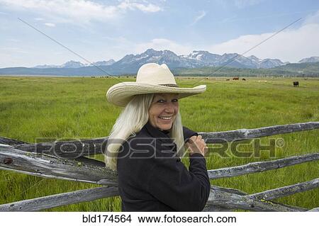 Picture - Caucasian woman standing in rural field. Fotosearch
