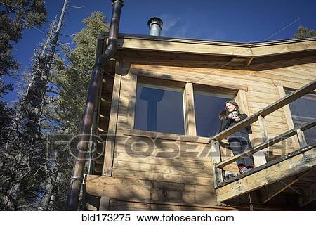 Stock Photography - Caucasian woman standing on cabin deck. Fotosearch