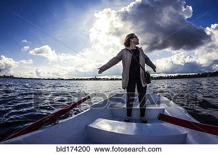 Caucasian woman standing on rowboat View Large Photo Image Stock Image - Caucasian woman standing on rowboat. Fotosearch
