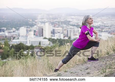 Caucasian woman stretching on hilltop over Salt Lake City, Utah, United States View Large Photo Image Stock Photography - Caucasian woman stretching on hilltop over Salt Lake City, Utah, United States. Fotosearch