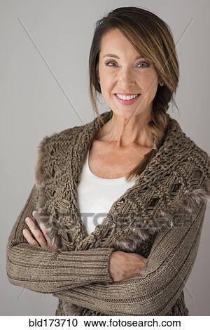 Stock Image - Caucasian woman with arms crossed. Fotosearch