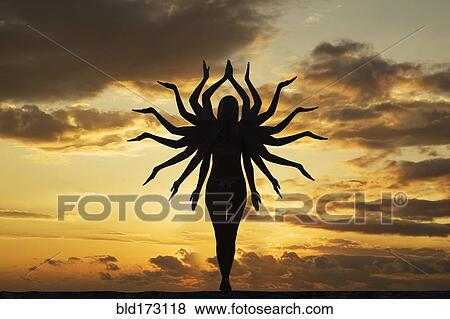 Caucasian woman with many arms under sunset sky View Large Photo Image Stock Photo - Caucasian woman with many arms under sunset sky. Fotosearch