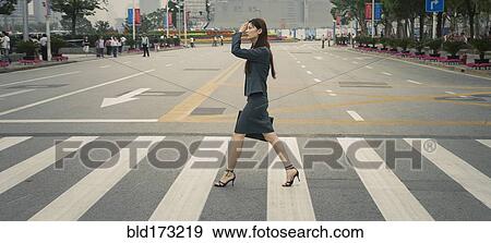 Stock Photo - Chinese businesswoman in pedestrian crossing. Fotosearch