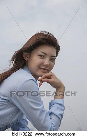 Chinese businesswoman smiling outdoors View Large Photo Image Stock Image - Chinese businesswoman smiling outdoors. Fotosearch