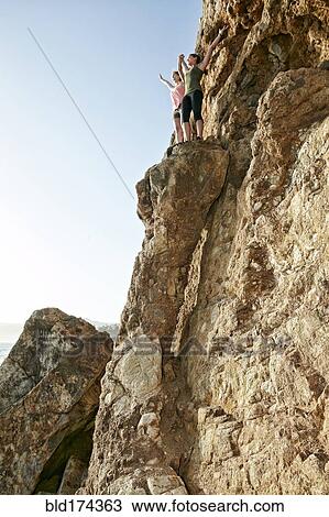 Climbers cheering on rock formation View Large Photo Image Stock Image - Climbers cheering on rock formation. Fotosearch